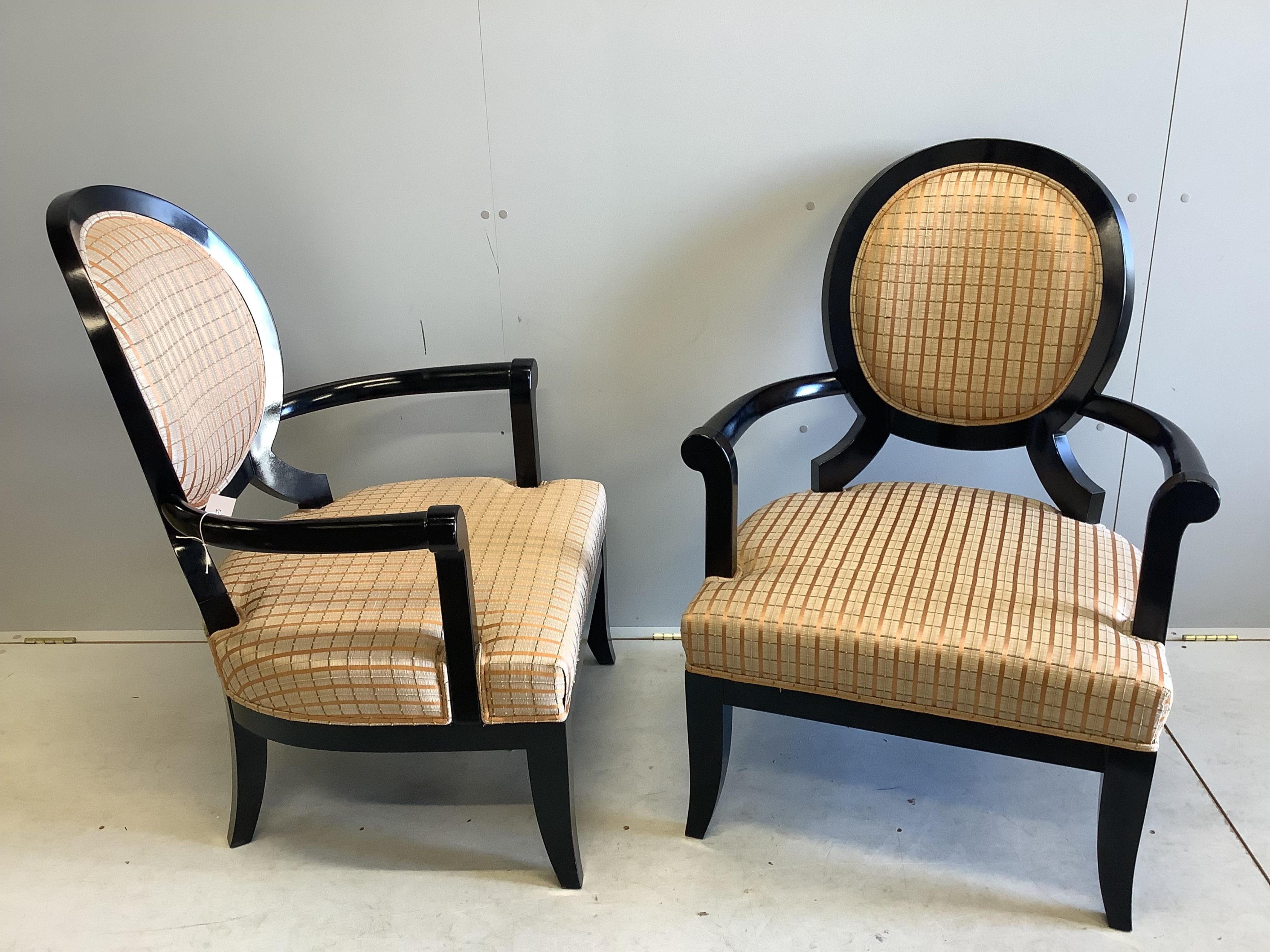 A pair of James Martin ebonised elbow chairs, width 74cm, depth 60cm, height 100cm. Condition - good